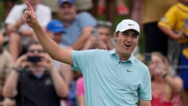 Scottie Scheffler exalts after holing a par putt on the final hole at the 2023 Players Championship.